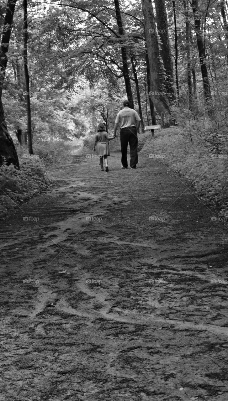 Black and white family hike image on muddy trail. 