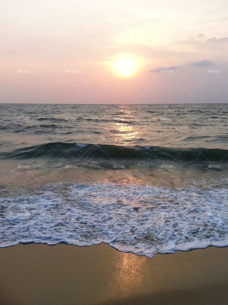 Last day of summer, setting sun above the waves