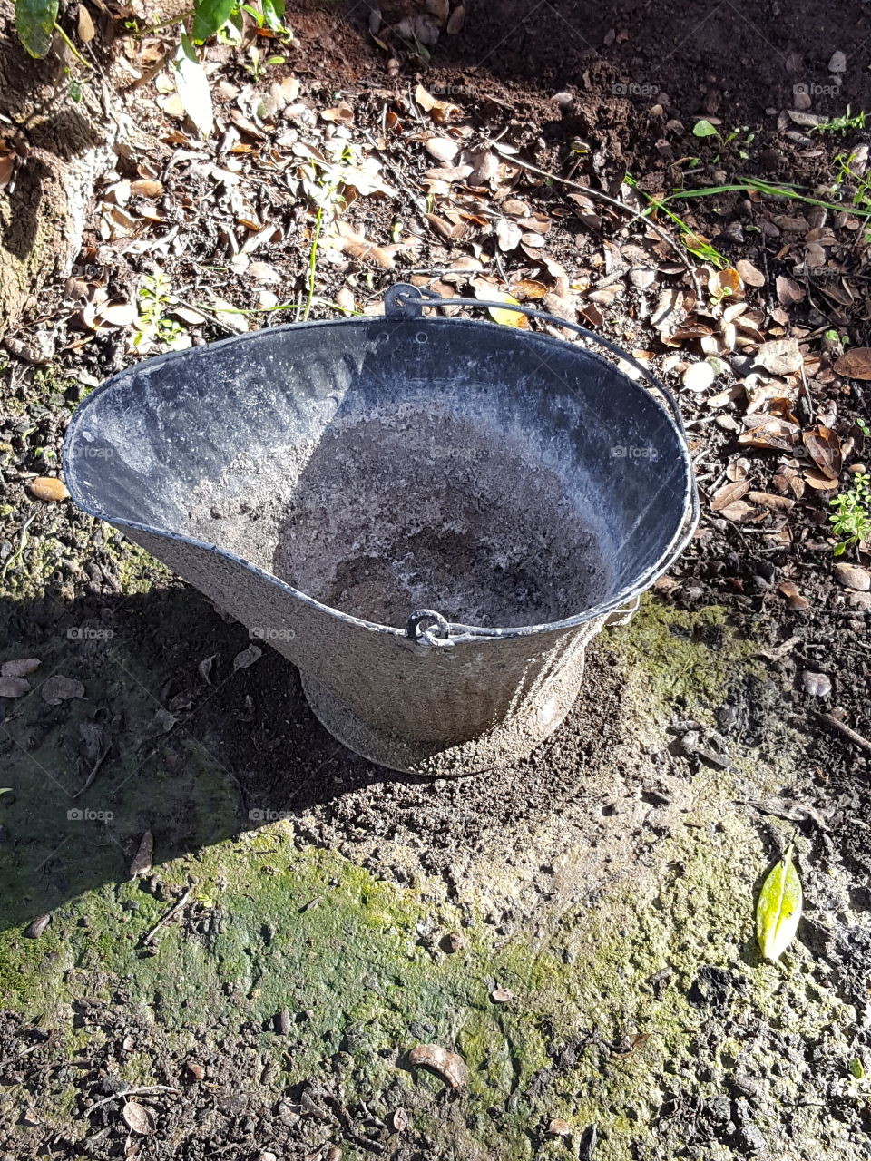 black bucket with gray ash