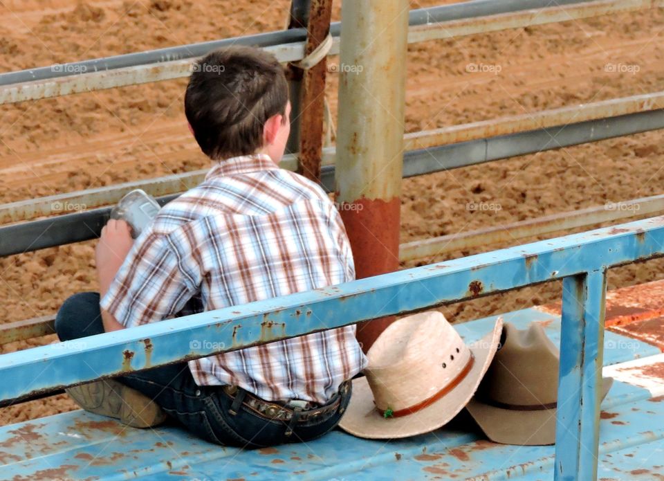 Cowboy at rodeo in stands 