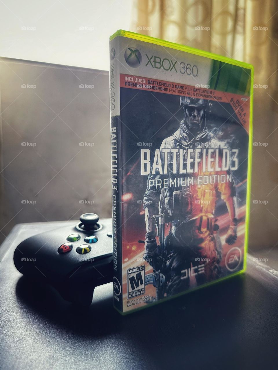 Battlefield video game box in front of a Xbox controller with natural light at the background.