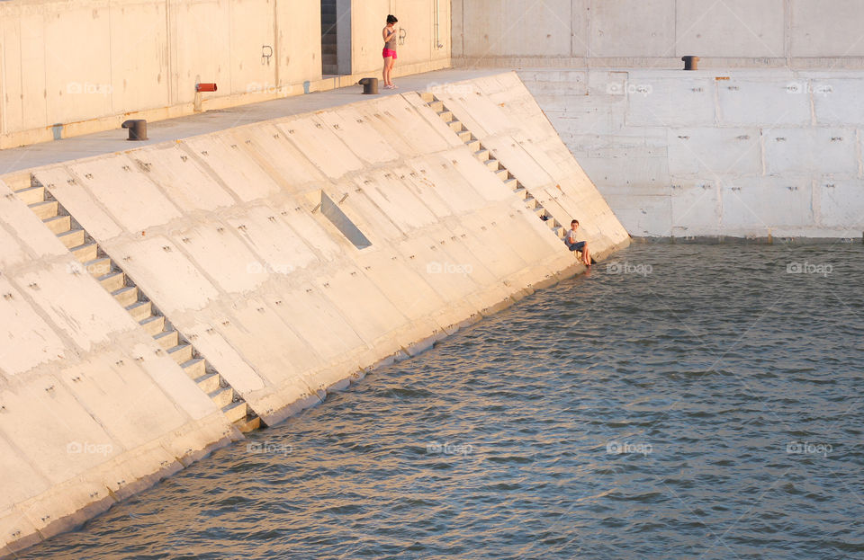 People on the river wall