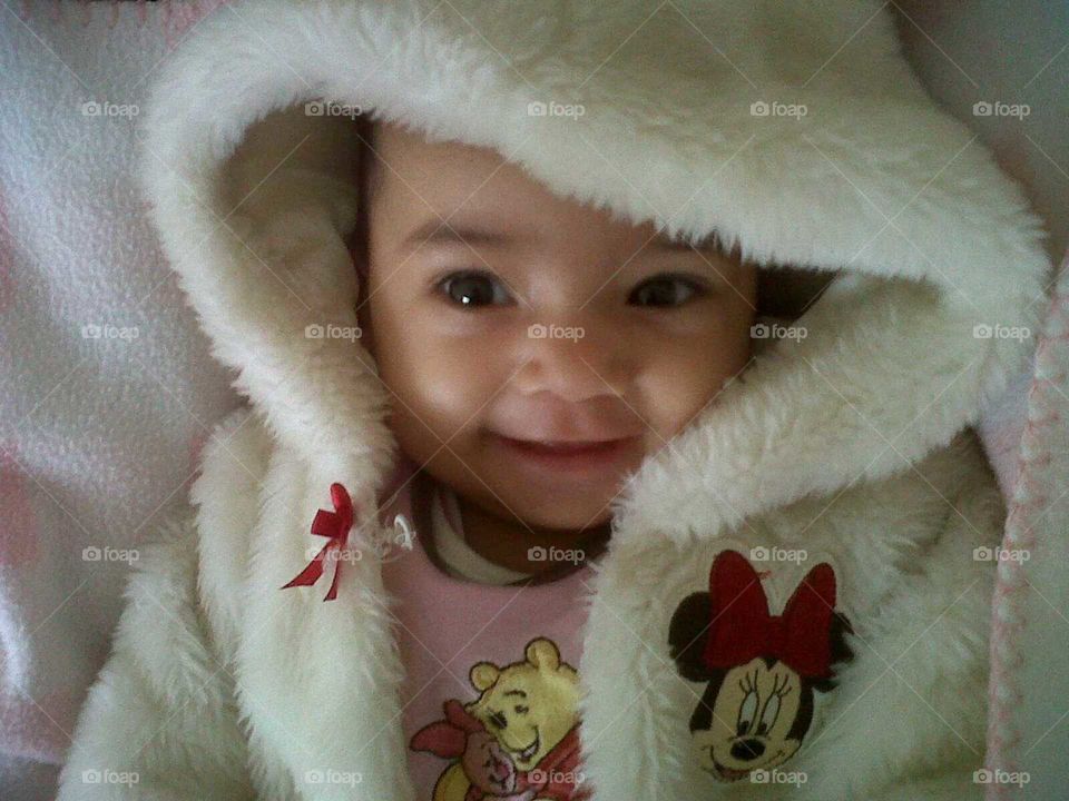 Happy baby girl dressed in a minnie mouse jacket