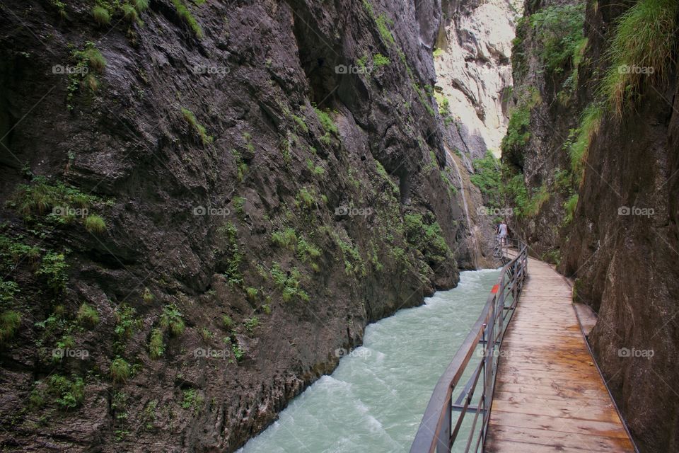 Large cliffs with fast river, walking path in aare gorge, switzerland