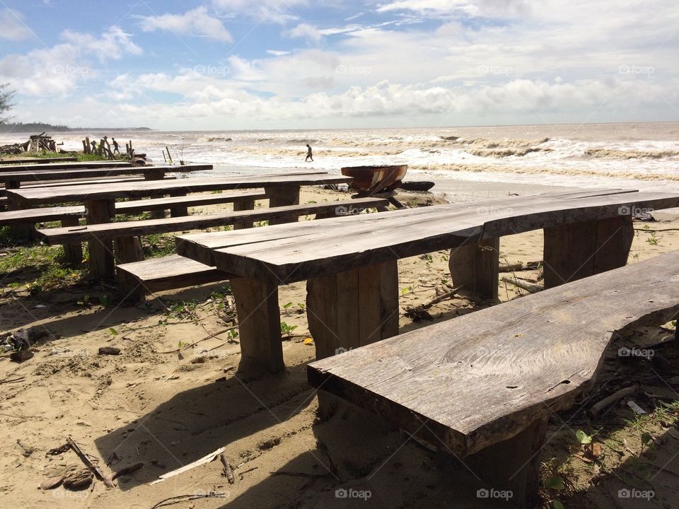 Empty wooden bench on beach