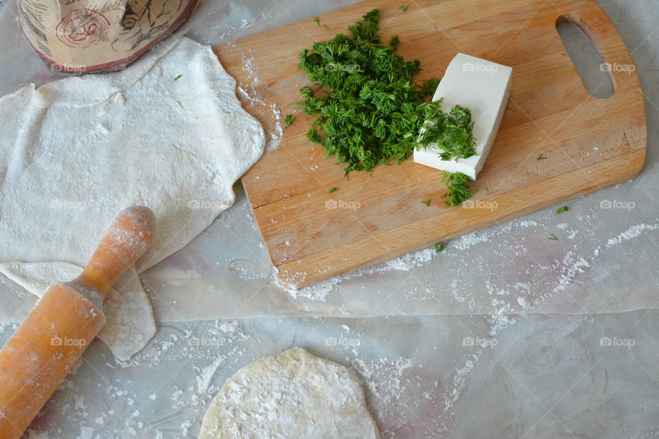 High angle view of rolling pin with dough