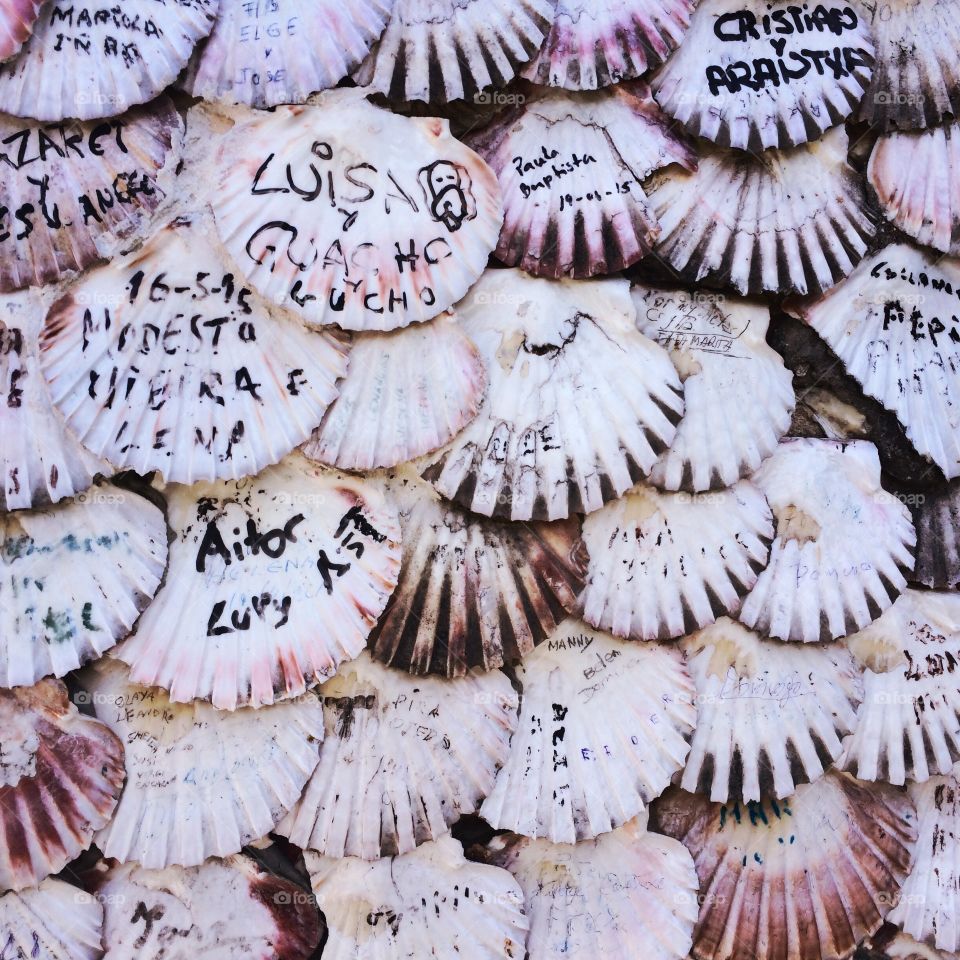 Wall church in spain plenty of shells  with names and messages