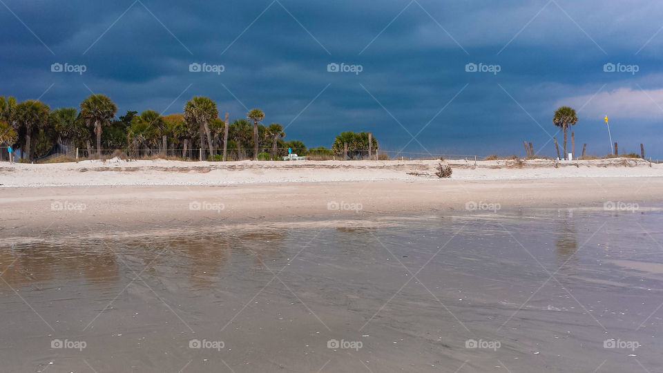 Edisto Beach. A dark angry sky blows over a cool, spring Edisto Beach.