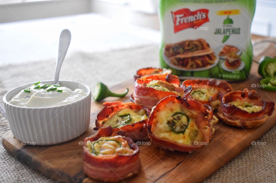 Crispy jalapeños with cheese wrapped in crispy bacon 