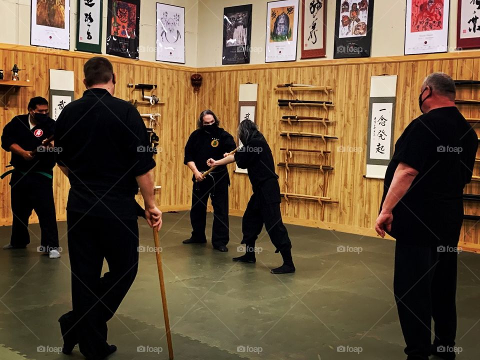 Martial arts training with the sensei while the other students look on. Watching and learning are part of the training at the dojo.