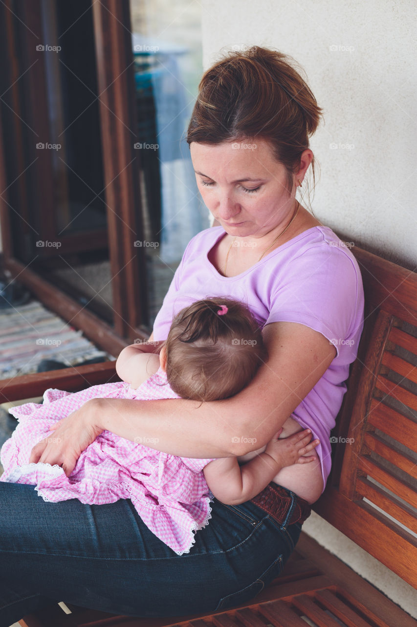 Mother breastfeeding her baby girl