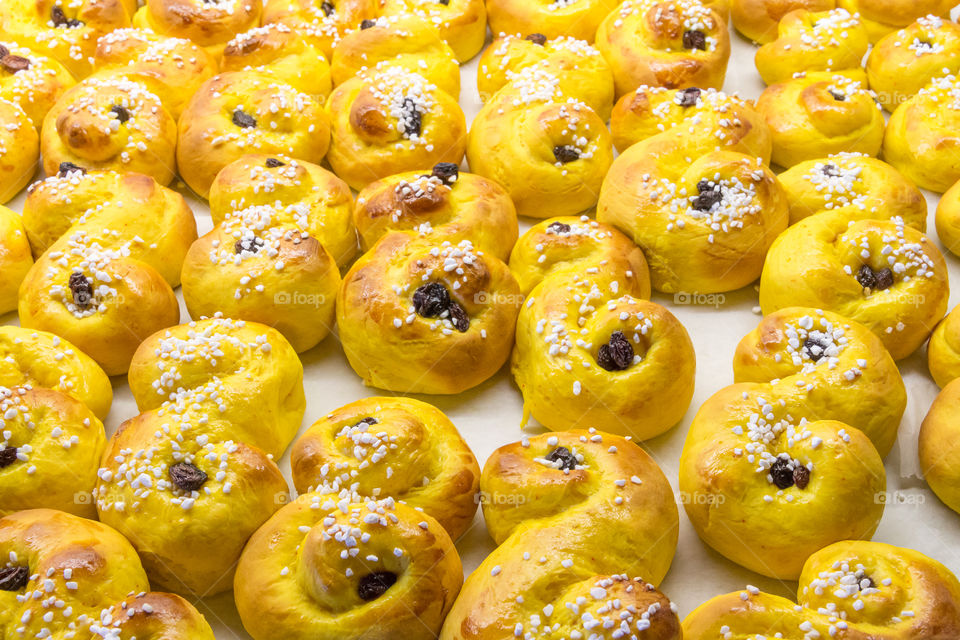 Homemade sweet saffron buns decorated with granulated sugar 