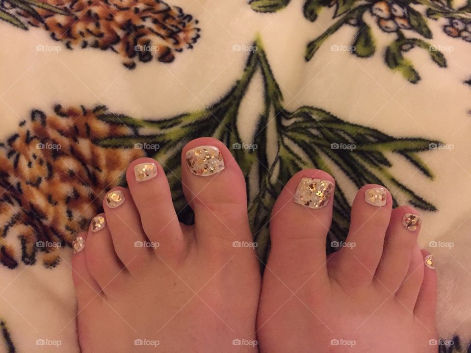 Beautiful white pedicure with gold sparkles 
