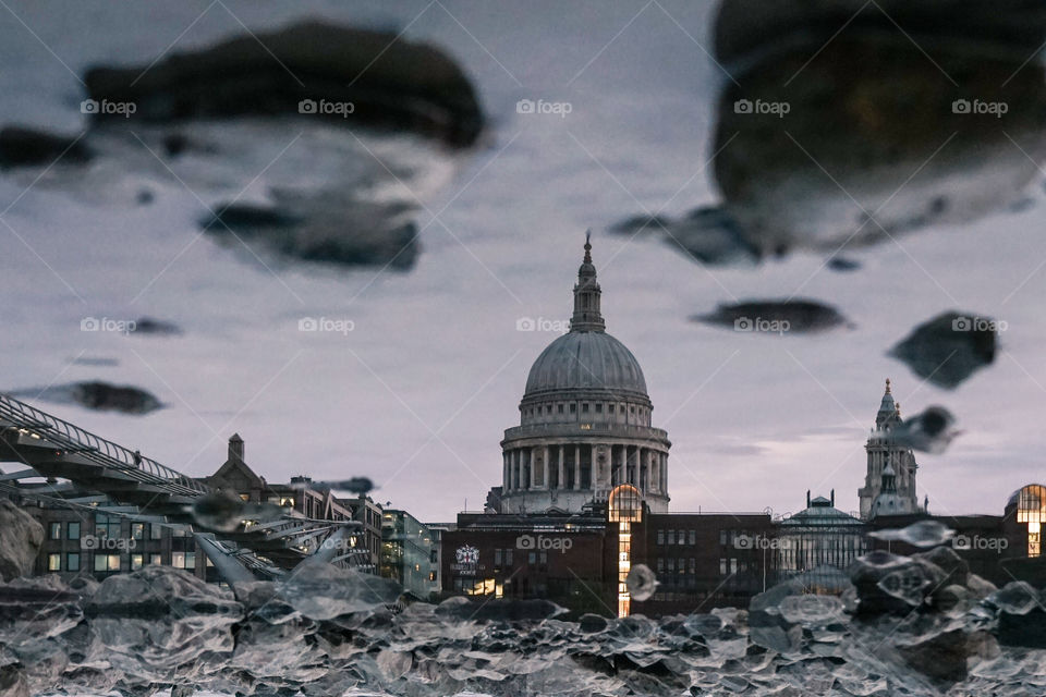A reflection of the iconic St. Paul's Cathedral London in a puddle of water