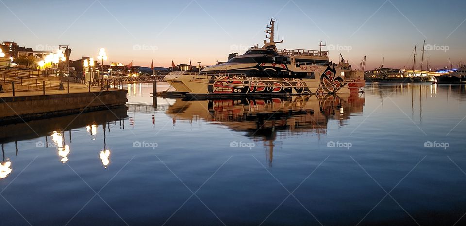 Boat reflection at the harbour at dusk