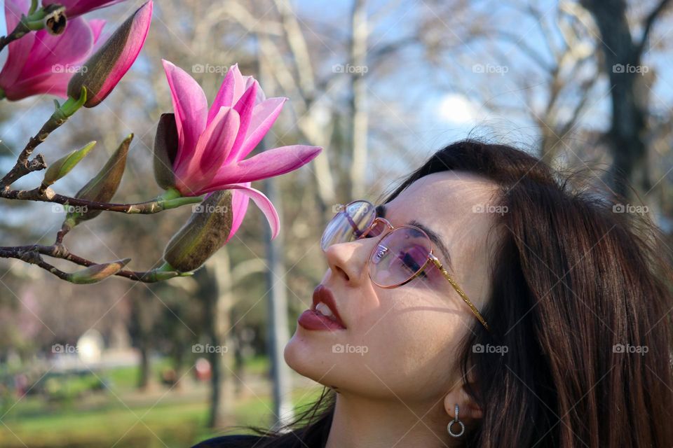 A girl smelling spring flowers
