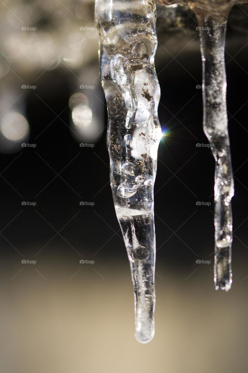 Close Up Of Icicles Hanging From A roof . Springtime.