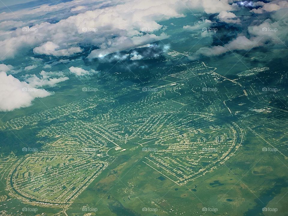 An aerial view of a round city below.