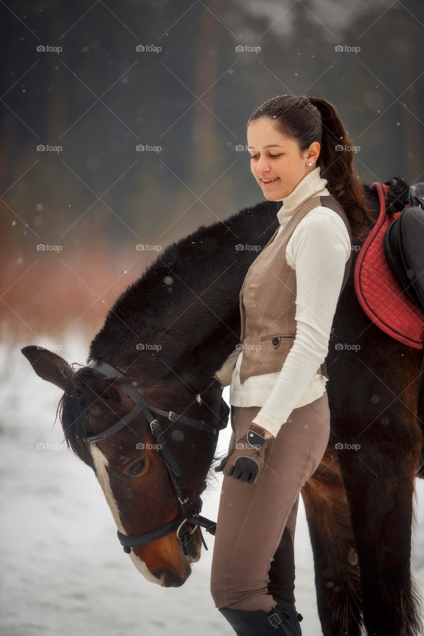 Young beautiful woman with horse outdoor portrait at spring day