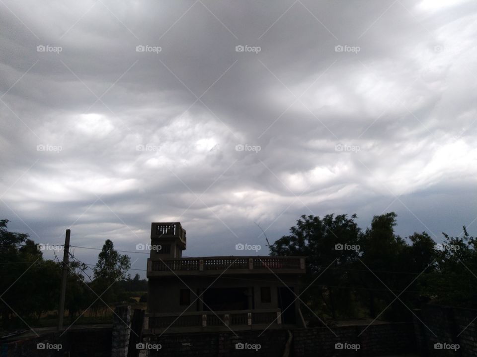 heavy black clouds in sky during rainy day ready to rain in Mohangarh village of india