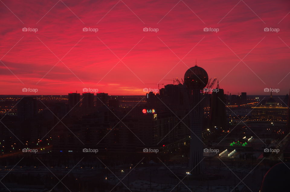  Exterior dusk.  Astana, Kazakhstan.    A red sky silhouettes the buildings of the nation’s capital.