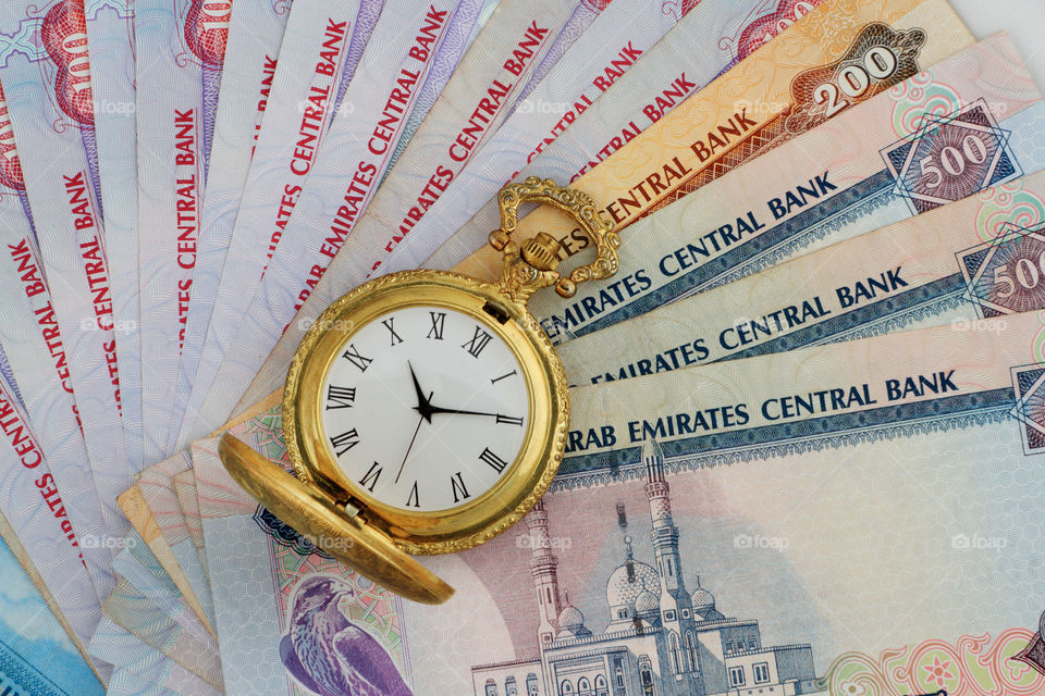 Uae dirham currency note with antique watch