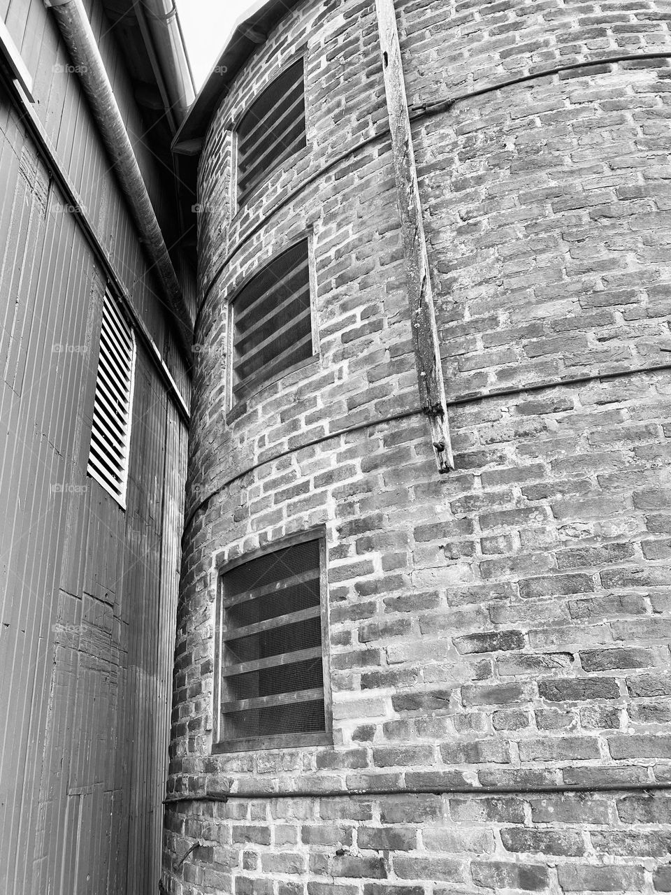An old silo next to a barn