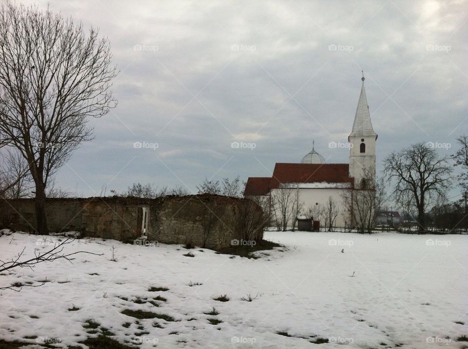 Winter scene with church in Luncani, Romania