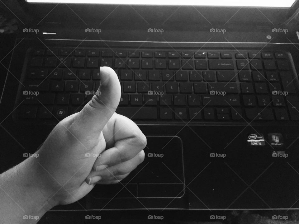 Thumbs up, working on the computer 