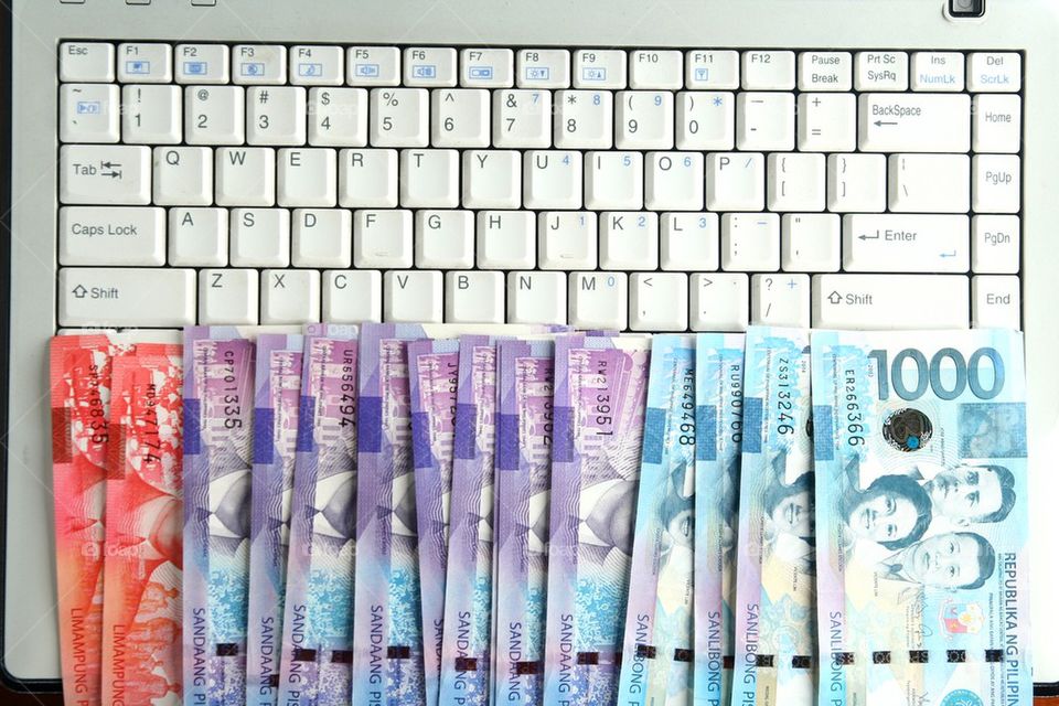 cash money on a laptop computer