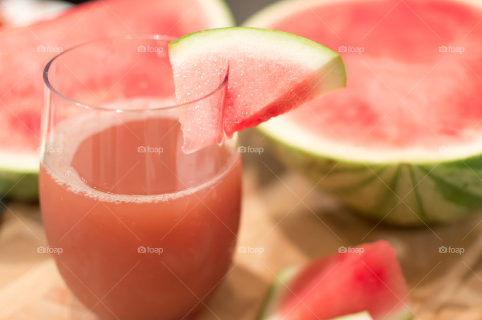 Home made juicing pink fresh watermelon with juice in glass and sliced sweet seedless watermelon healthy refreshing drink background photography