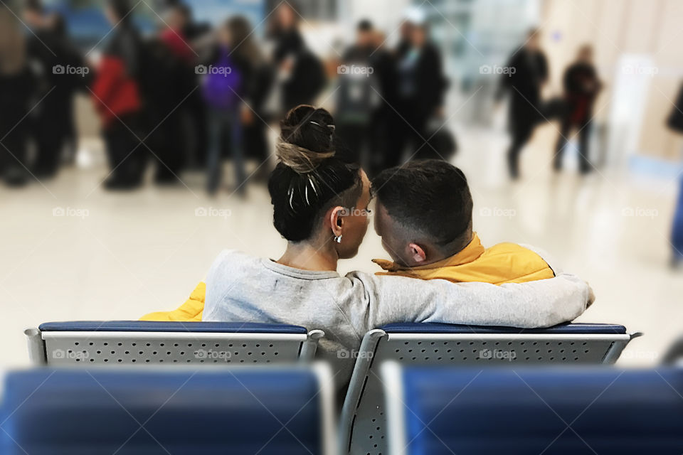 Couple in love sitting at the airport 