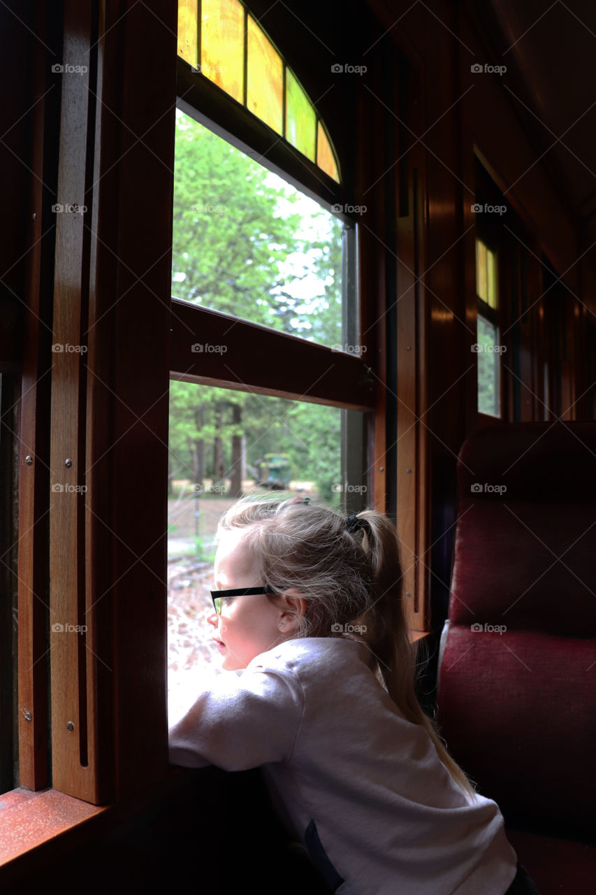 Child looking out the window in a train