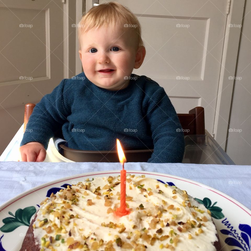 Portrait of toddler boy with birthday cake