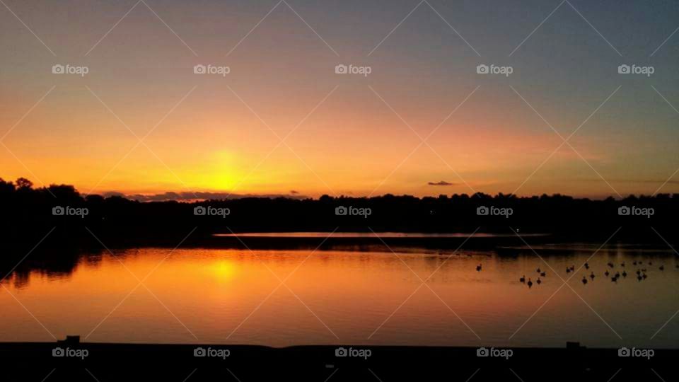 Scenic view of lake at dusk