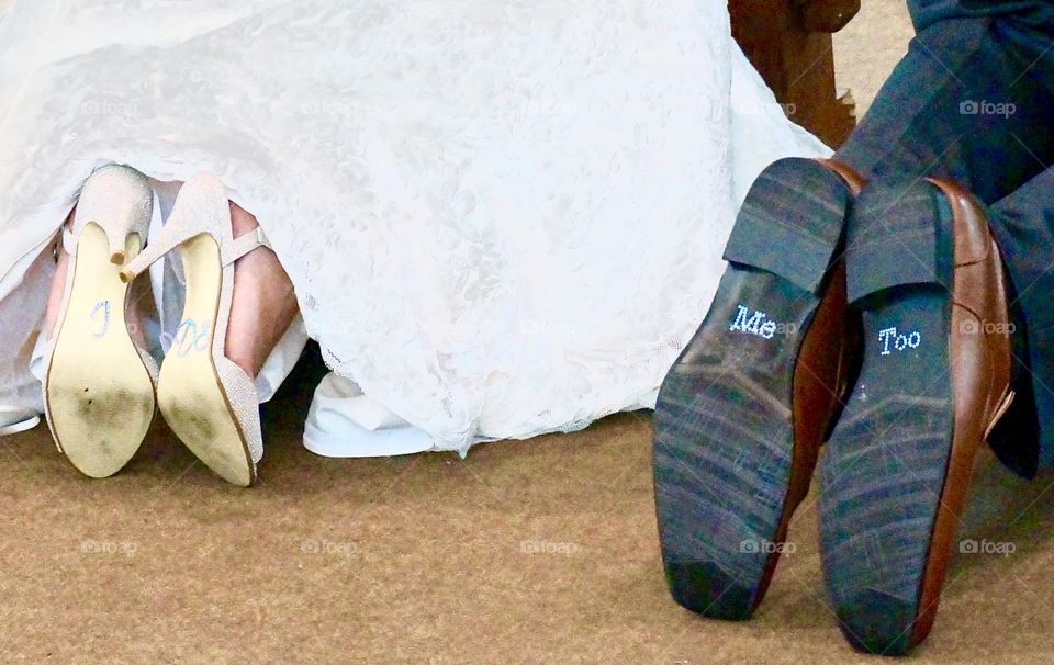 Bride and groom wearing footwear with text