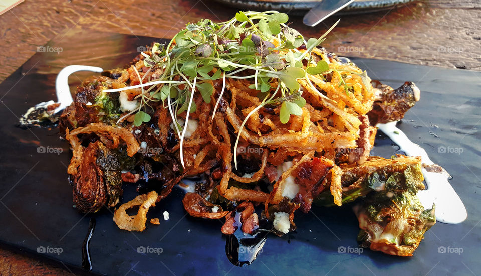 Food is served, Brussels sprouts with caramelized onion rings