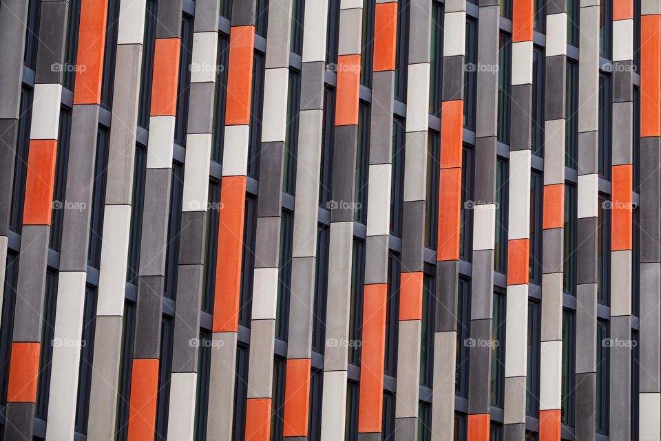 Orange and grey facade of modern office building Main Point Karlin in Prague.