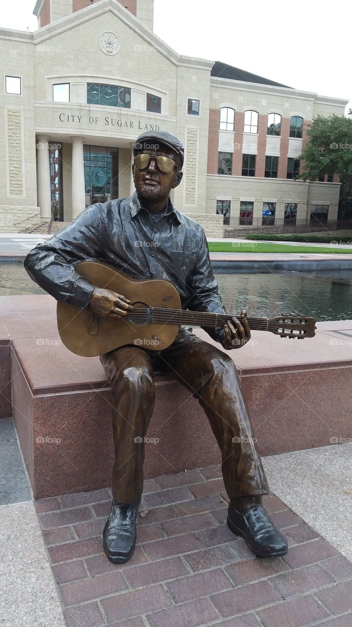Guitar player statue