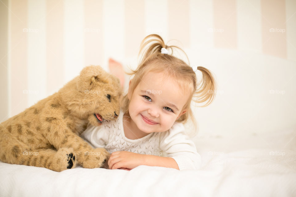 Portrait of a cute girl with soft toy