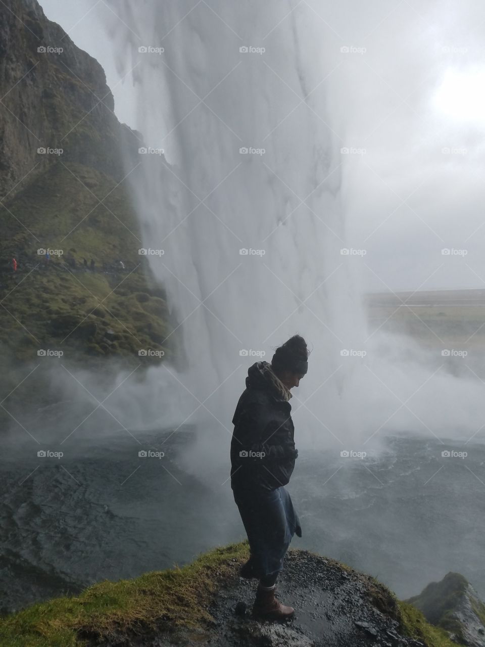 behind the waterfall