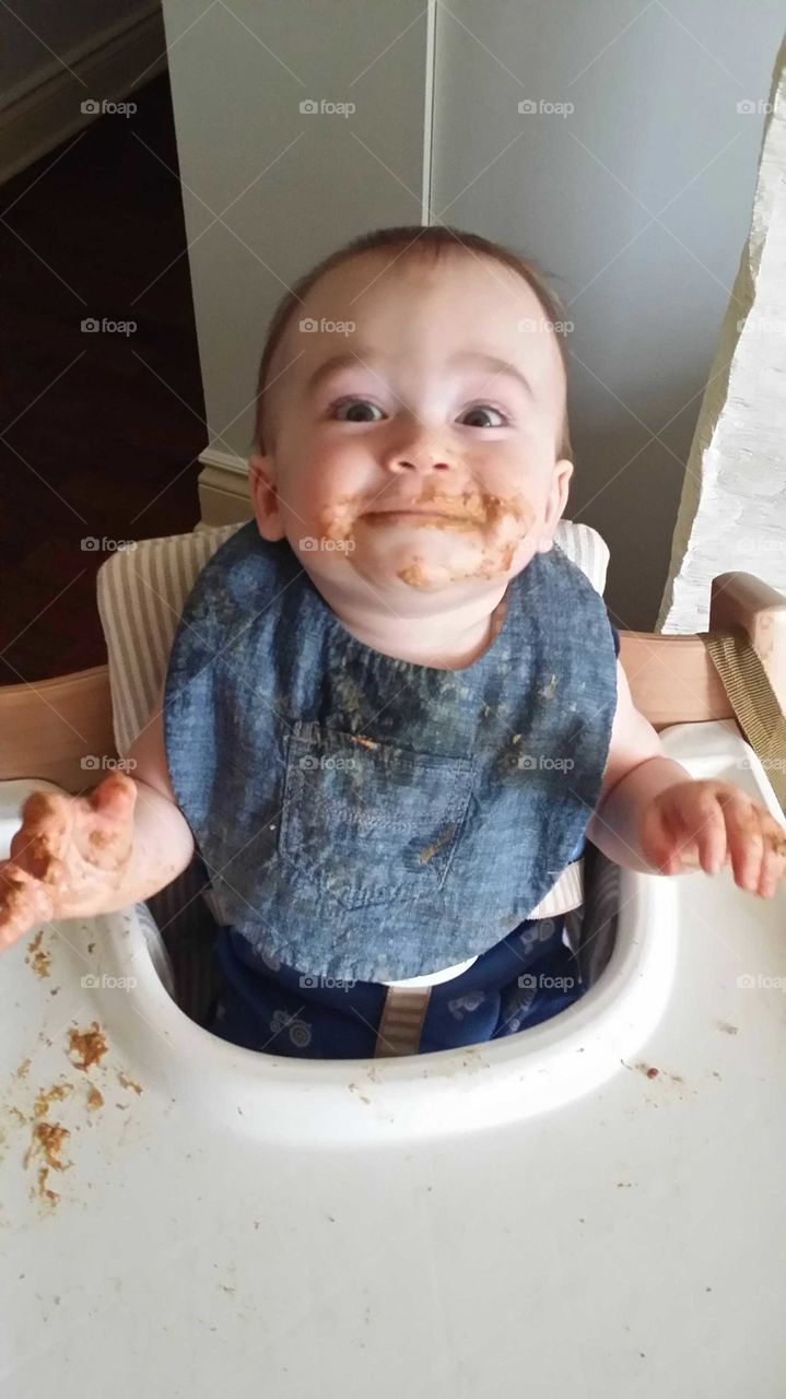 Baby eating and smiling!