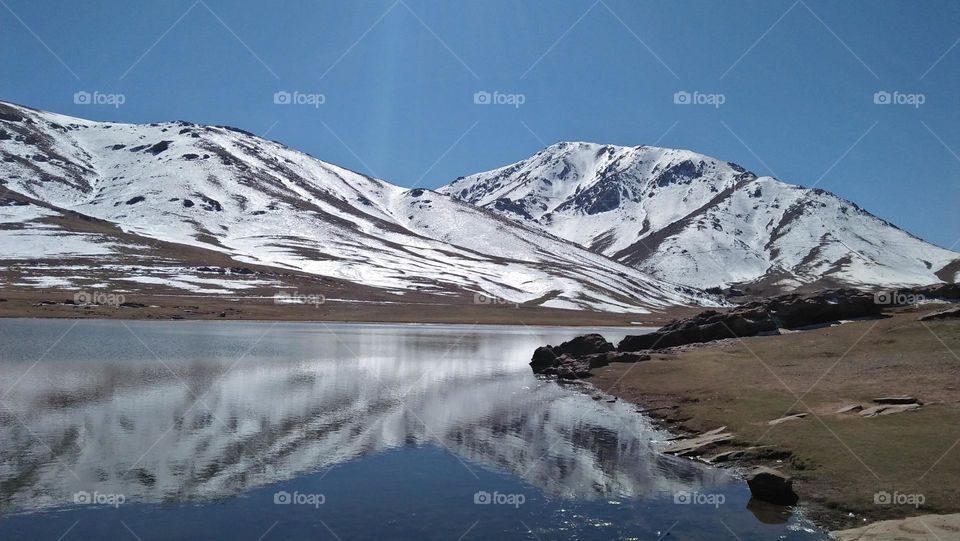 magic lake and high mountain covered by snow.