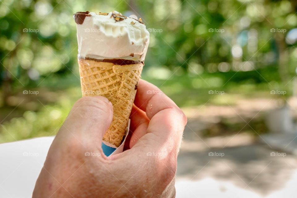 Hand holding ice cream cone
