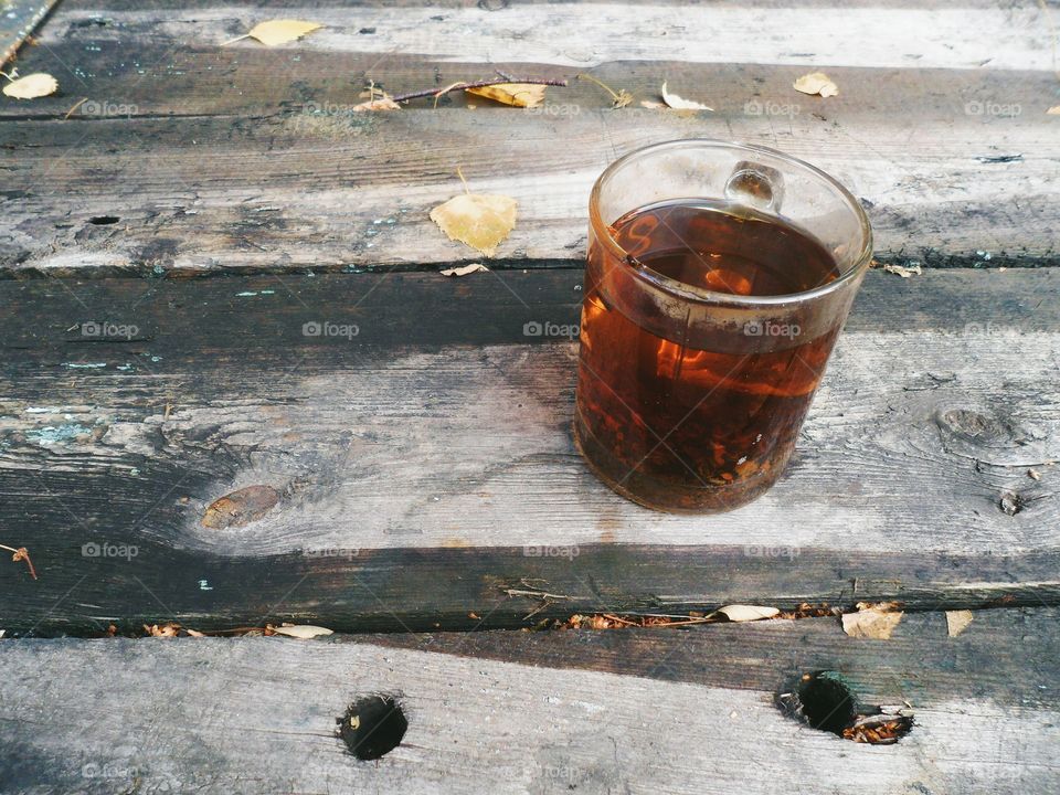 cup of black tea on an old wooden table