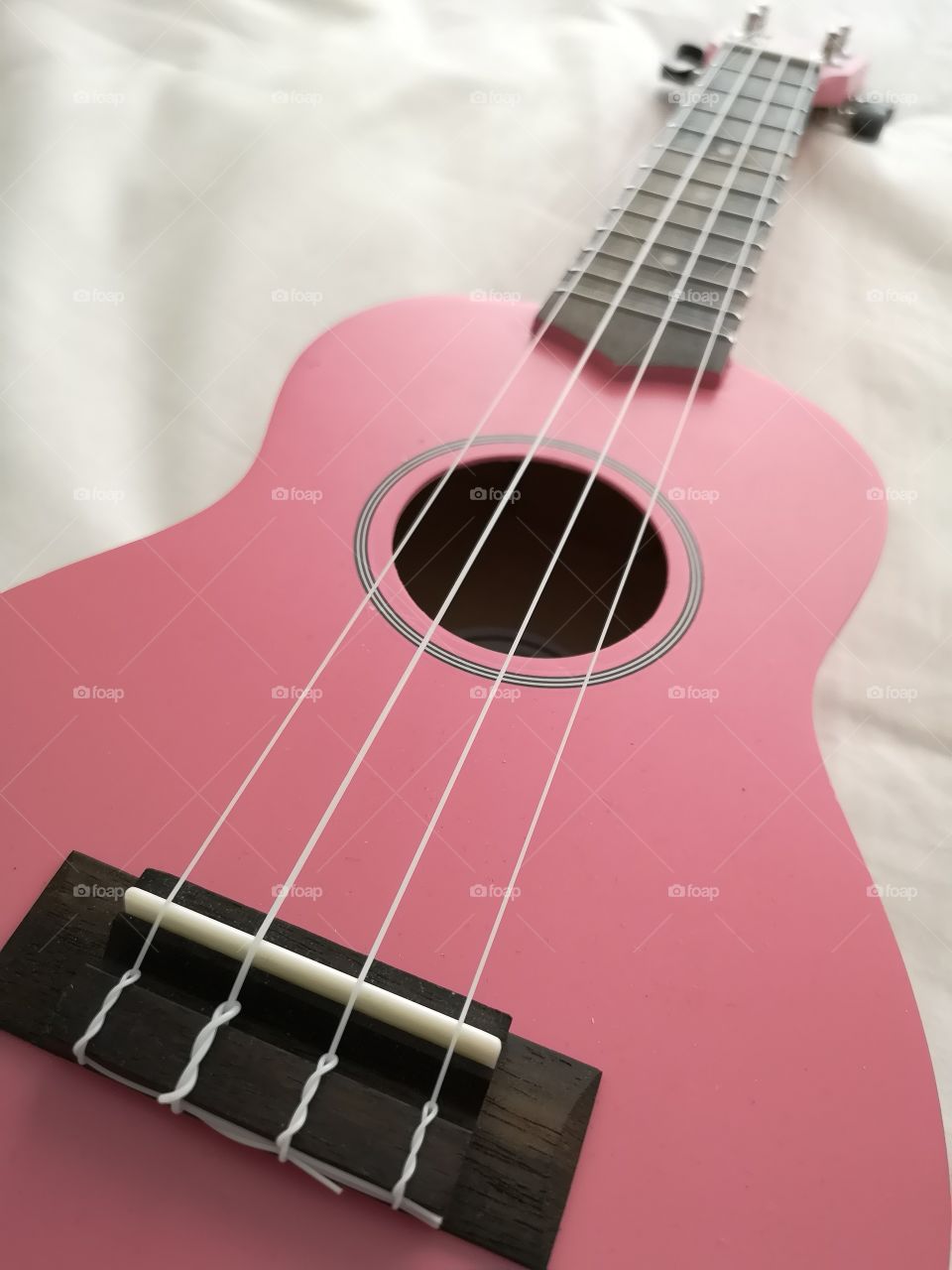 Pink ukulele guitar closeup