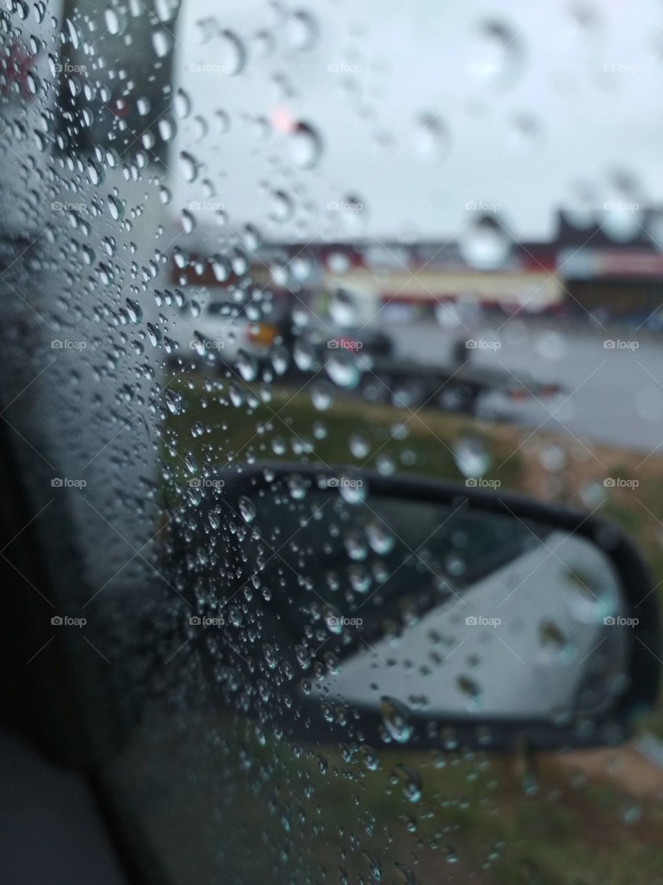 Rain production on the window in the car