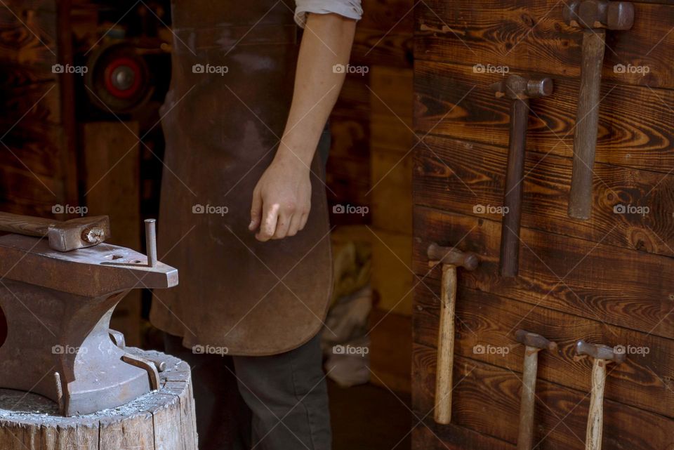 The blacksmith forges a horseshoe.  Iron forging machine close-up.