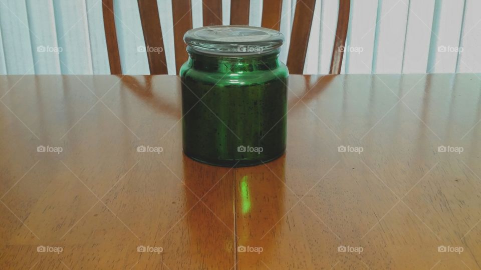 Green glow from sunlight shining through a jar, Backlot by light through aqua window shades