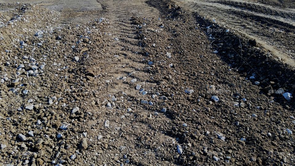 tire tracks on dirt and rock, construction